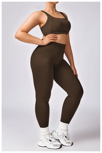 Detail view of dark brown sports bra and high-waisted yoga leggings on model