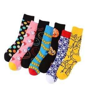 Colorful crew socks with smiley faces and checkerboard patterns on white background