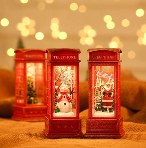 Close-up of lighted red Christmas telephone booth lanterns with Santa and snowman scenes