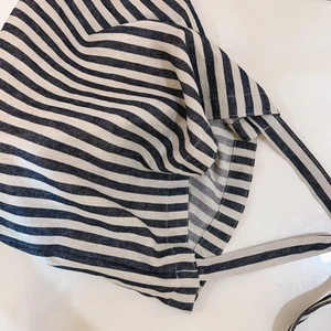 Detailed view of the thick canvas fabric texture on a vintage striped tote bag