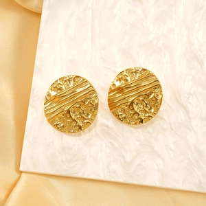 18K gold plated round earrings with hammered crinkle texture on marble surface