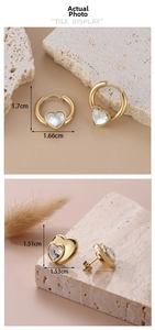 Detail showing dimensions of gold heart earrings and hoops with transparent crystals