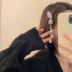 Silver ethnic hollow tassel hair clip with vintage diamond accents in a mirror selfie view