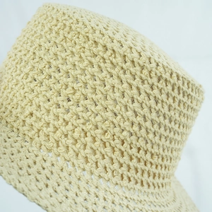 Beige hand-woven straw Panama hat featuring intricate hollow crochet pattern and wide brim