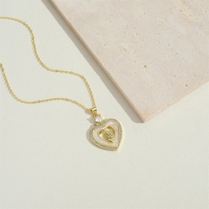 Exquisite gold heart pendant necklace with micro-pave crystals and central cameo relief