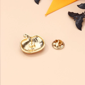 Macro view of golden Halloween pumpkin brooch back with butterfly clutch fastener