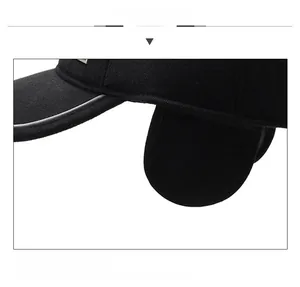 Detail view of winter baseball cap with earflaps and reflective trim for warmth