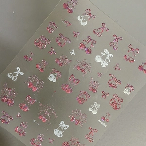 Close-up of pink glitter cherry and bow nail stickers with cheery text and ta-385 model