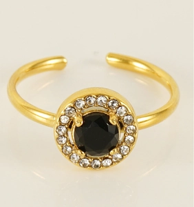 Detail of adjustable gold ring featuring a black center stone and zircon pavé setting