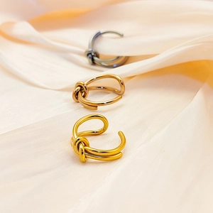 Three knot rings in gold, silver, and rose gold on silk background with 18K plating