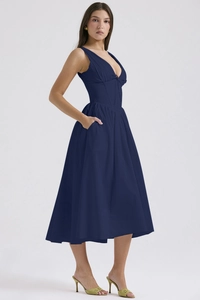 Detailed close-up of a navy blue V-neck midi dress featuring corset waist and side pockets