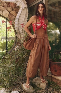 Detailed view of women's vertical stripe casual pants and suede texture crossbody bag