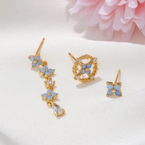 Elegant gold flower earring set with light blue stones and white zircon details