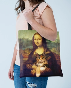 Detail of creative canvas tote bag featuring Mona Lisa print with wide black shoulder straps
