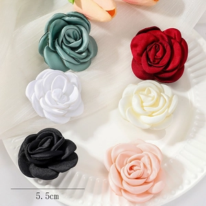 Detail showing various 5.5cm satin fabric rose brooches in multi-color vintage style