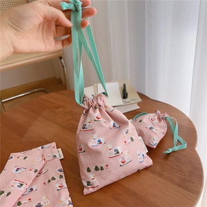 Detailed view of pink cotton drawstring pouches with cute duck and rabbit patterns