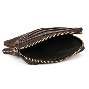 Detail view of dark brown genuine leather coin purse with golden zippers and white stitching