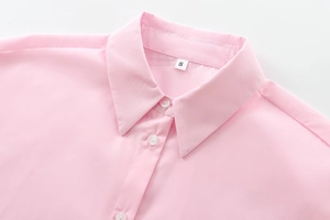 Close-up of pink cotton shirt collar with neat stitching and white resin buttons