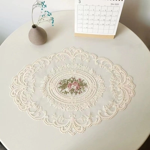 Oval off-white lace placemat with elegant pink rose embroidery and vintage floral edges