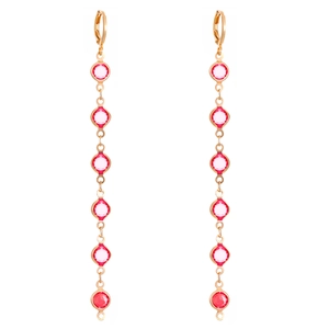 Macro view of long gold drop earrings with six pink crystal stones on white background
