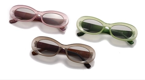 Close-up of translucent oval sunglasses with CE and UKCA quality certification markings