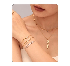 Detail of infinity design necklace and bracelet set with cubic zirconia on model