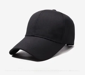 Detail view of black canvas baseball cap with metal SPORTS logo and twill texture