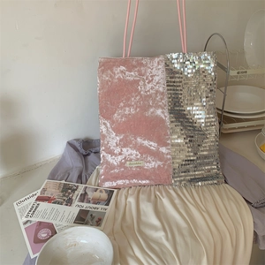 Detail of pink velvet and silver sequin patchwork tote bag with a woven brand label
