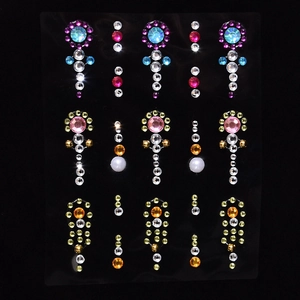 Detail showing various colors and shapes of face gemstone stickers on transparent cards