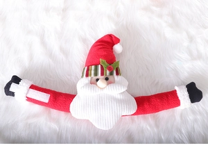 Detail of Santa Claus curtain tieback with red knit hat and plush texture on white background