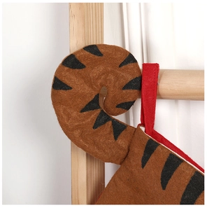 Detail of tiger print Christmas stocking with unique curled tail and red hanging loop