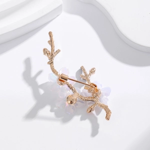 Elegant gold plum blossom brooch with white floral petals on a clean white background