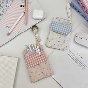 Detail of floral canvas nurse pouches with flap pockets and snap button handles
