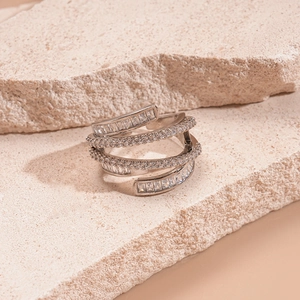 Macro detail of multilayer silver ring with pavé cubic zirconia and baguette stones