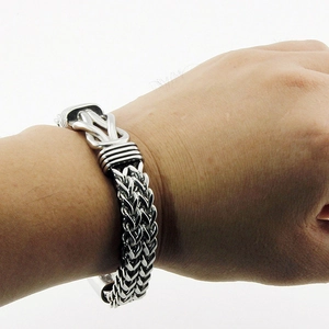 Close-up of double-row stainless steel punk bracelet with knot design on wrist