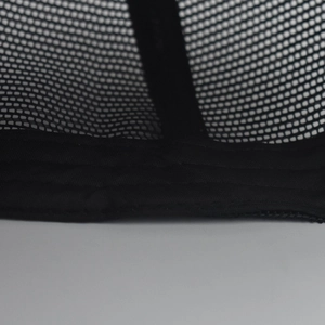 Macro detail of breathable black mesh panel and reinforced stitching on baseball cap