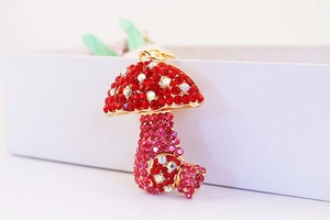 Close-up of sparkling mushroom keychain with vibrant red and pink rhinestones