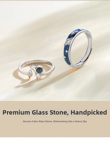 Close-up of S925 silver astronaut rings featuring deep blue star-themed glass stone