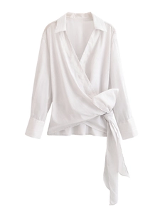 Detail of white striped wrap shirt with side bow tie and long sleeves on white background