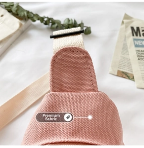 Close-up detail of premium pink canvas fabric and adjustable strap on a kids chest bag
