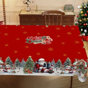 Detail of Christmas tablecloth with Santa and snowman print on a wooden cabinet