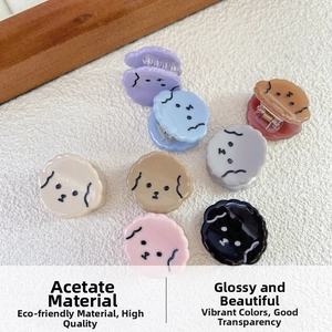 Detail of mini acetate hair clips in cute dog shapes showing various colors and textures