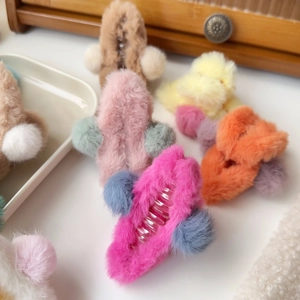 Close-up of soft plush hair claws in various colors with faux fur texture detail