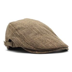 Detailed view of dark brown plaid ivy cap featuring a side metal buckle and woven texture