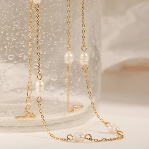Elegant gold stainless steel necklace with delicate white pearls in a soft-toned setting