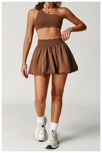 Detail of a brown pleated tennis skirt with high waist and breathable performance fabric