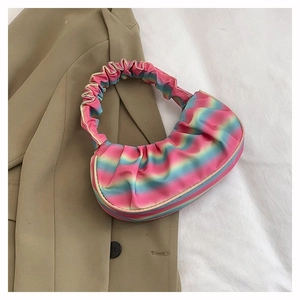 Rainbow gradient pleated shoulder bag with a cloud-shaped design on a beige blazer