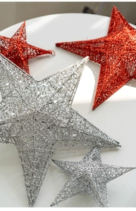 Detailed close-up of glittery red and silver iron star ornaments for Christmas decoration
