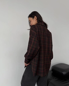 Detail of loose-fit plaid shirt in dark brown and deep red with drop shoulder seam