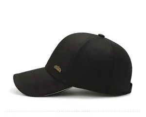 Detail view of the black cotton baseball cap showing the side bronze mountain emblem